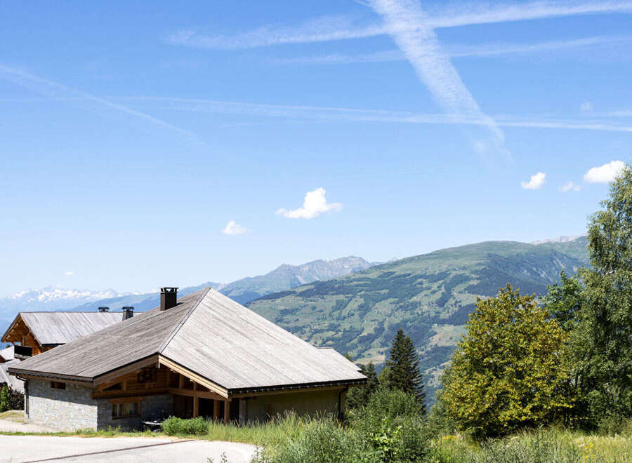 Experience the charm of alpine living in this stunning property, featuring traditional wooden architecture and stone accents.