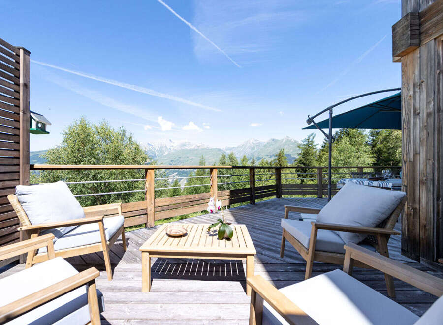 Enjoy breathtaking mountain views from this stunning wooden deck, perfect for outdoor entertaining or relaxing.