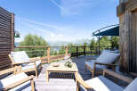 Enjoy breathtaking mountain views from this stunning wooden deck, perfect for outdoor entertaining or relaxing.