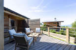 Enjoy breathtaking mountain views from this charming wooden deck, perfect for relaxing or entertaining.
