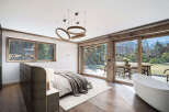 Experience luxury living in this stunning bedroom, featuring a modern design with a touch of rustic charm.