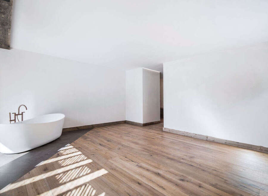 This stunning bathroom features a modern, minimalist design with a sleek, freestanding bathtub.
