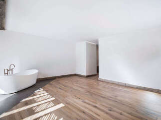 This stunning bathroom features a modern, minimalist design with a sleek, freestanding bathtub.