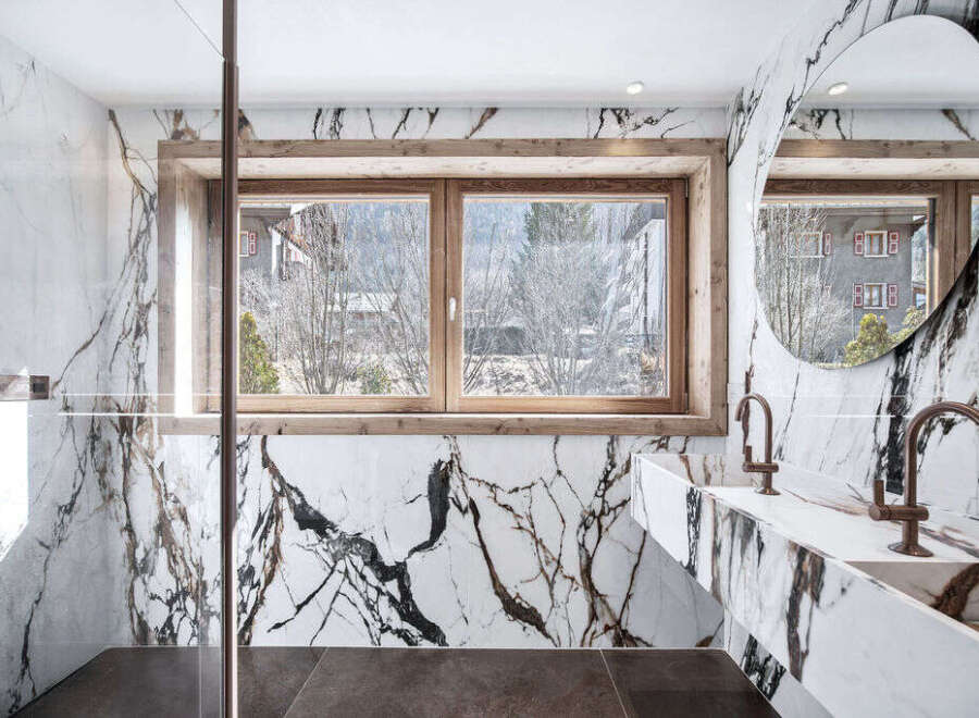 Experience luxury in this stunning bathroom featuring exquisite marble finishes and a serene ambiance.