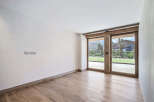 Step into a bright and airy room, featuring stunning wooden floors that exude warmth and elegance.