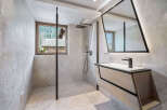 Experience luxury in this modern bathroom, featuring a sleek glass shower and a stylish vanity.