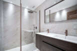 Step into a modern bathroom oasis, featuring a sleek shower enclosure and a stylish double vanity.