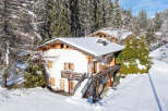 Nestled in a serene winter wonderland, this charming chalet offers a perfect blend of comfort and natural beauty.