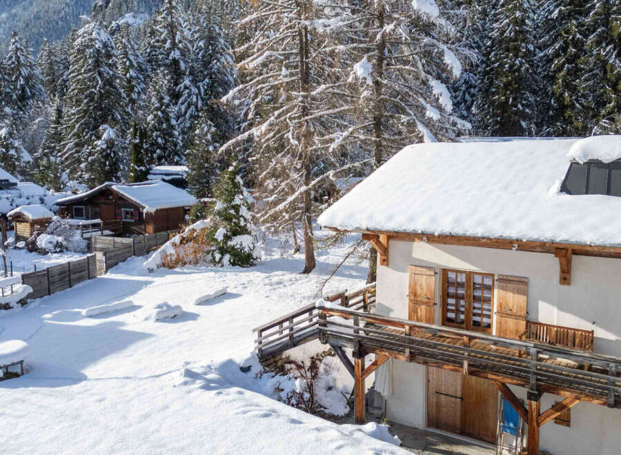 Discover the charm of this stunning winter chalet nestled in a snowy landscape.