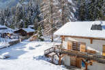 Discover the charm of this stunning winter chalet nestled in a snowy landscape.