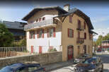 This charming property features a classic architectural design with a combination of light and dark colors.