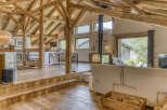 Experience rustic elegance in this stunning property featuring exposed wooden beams and a cozy fireplace.