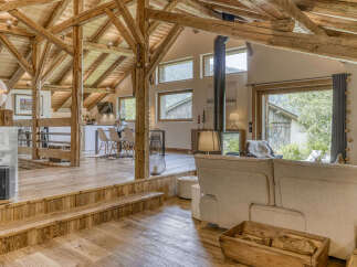 Experience rustic elegance in this stunning property featuring exposed wooden beams and a cozy fireplace.