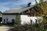 Charming alpine house with a unique blend of traditional wooden architecture and modern white walls.