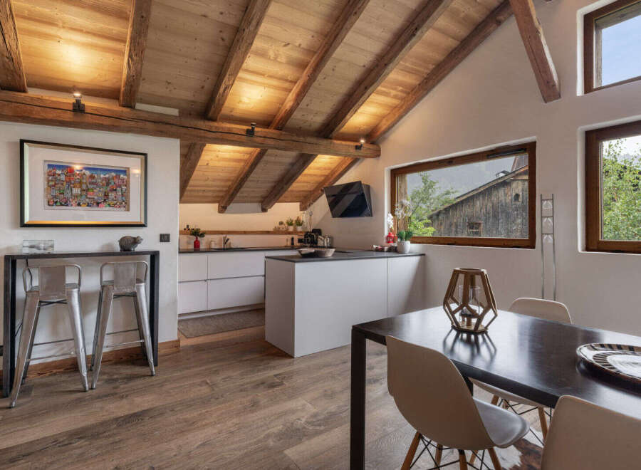 Experience rustic charm and modern convenience in this stunning mountain chalet kitchen and dining area.