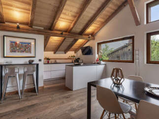 Experience rustic charm and modern convenience in this stunning mountain chalet kitchen and dining area.