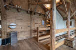 Experience rustic charm in this beautifully appointed wooden interior, featuring exposed beams and natural wood finishes throughout.