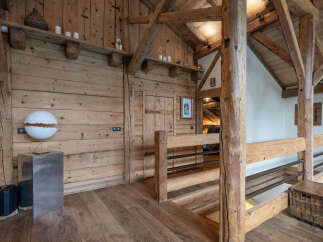 Experience rustic charm in this beautifully appointed wooden interior, featuring exposed beams and natural wood finishes throughout.