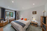 Discover this charming bedroom featuring a comfortable bed adorned with decorative pillows and a cozy throw.