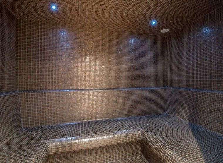 Step into luxury with this stunning steam room, meticulously crafted with intricate mosaic tiles.