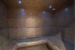 Step into luxury with this stunning steam room, meticulously crafted with intricate mosaic tiles.