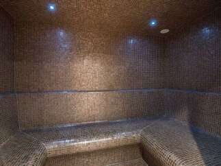 Step into luxury with this stunning steam room, meticulously crafted with intricate mosaic tiles.