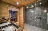 Step into luxury with this stunning bathroom featuring a modern shower and elegant double sinks.
