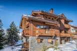 This stunning wooden chalet offers a luxurious retreat in a picturesque winter setting.