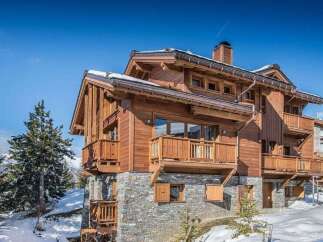This stunning wooden chalet offers a luxurious retreat in a picturesque winter setting.