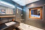This modern bathroom features a sleek design with a combination of functionality and style.