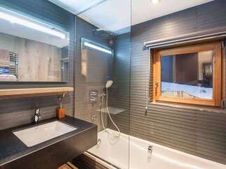 This modern bathroom features a sleek design with a combination of functionality and style.