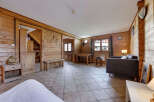 This charming property features a cozy living space with warm wooden paneling throughout.