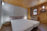 This cozy bedroom features a rustic design with wooden accents and a textured wall.
