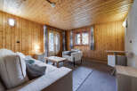 Step into this cozy cabin retreat, featuring warm wood paneling and a welcoming atmosphere.