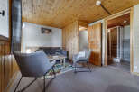 Discover the charm of this cozy property, featuring a comfortable living area with stylish gray chairs and a sofa.