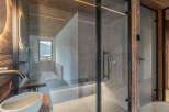 Experience luxury in this stunning bathroom featuring a modern glass shower and elegant sink.