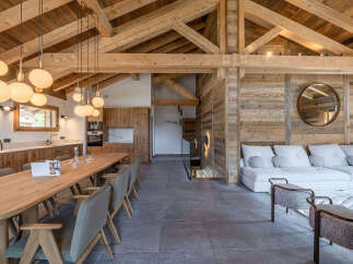 Experience luxury living in this stunning property, featuring a beautifully designed interior with exposed wooden beams and a modern aesthetic.