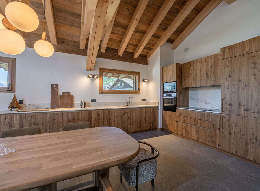Experience the warmth of this stunning kitchen, featuring custom wooden cabinetry and a spacious layout perfect for entertaining.