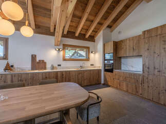 Experience the warmth of this stunning kitchen, featuring custom wooden cabinetry and a spacious layout perfect for entertaining.