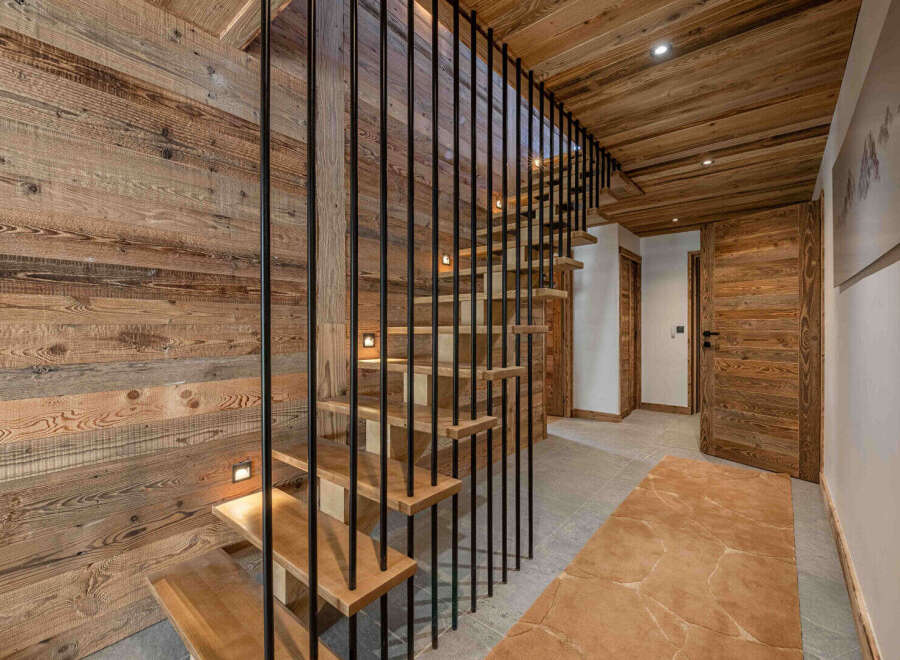 This stunning property boasts a beautifully crafted wooden staircase, creating a warm and inviting atmosphere.