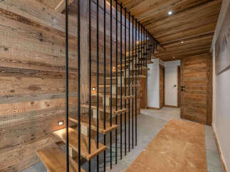 This stunning property boasts a beautifully crafted wooden staircase, creating a warm and inviting atmosphere.