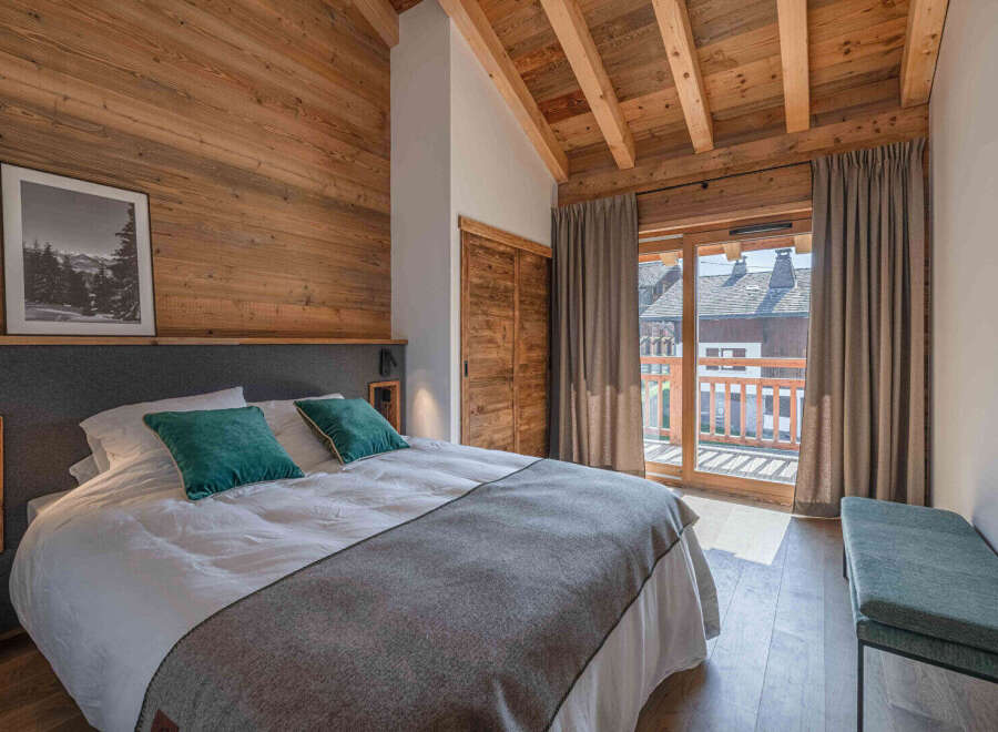 This cozy bedroom features a rustic wooden design, creating a warm and inviting atmosphere.