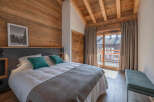 This cozy bedroom features a rustic wooden design, creating a warm and inviting atmosphere.
