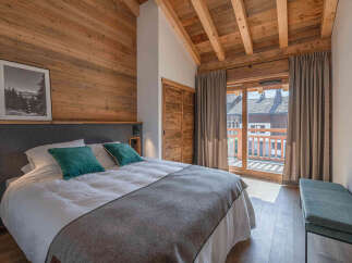 This cozy bedroom features a rustic wooden design, creating a warm and inviting atmosphere.