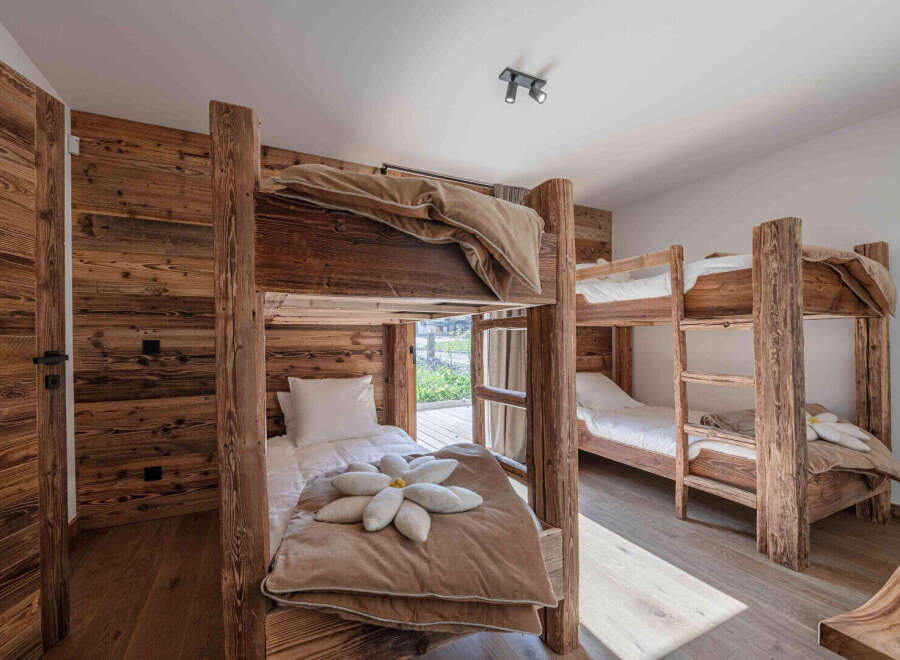 This cozy bedroom features rustic wooden bunk beds, perfect for a family or group getaway.