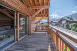 Experience the charm of this stunning wooden chalet, featuring a spacious balcony with breathtaking mountain views.