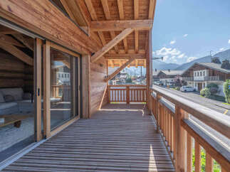 Experience the charm of this stunning wooden chalet, featuring a spacious balcony with breathtaking mountain views.