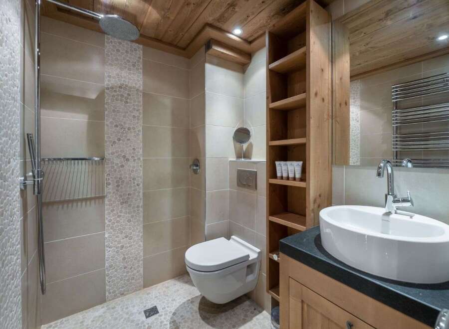 This luxurious bathroom features a modern design with a touch of rustic charm.