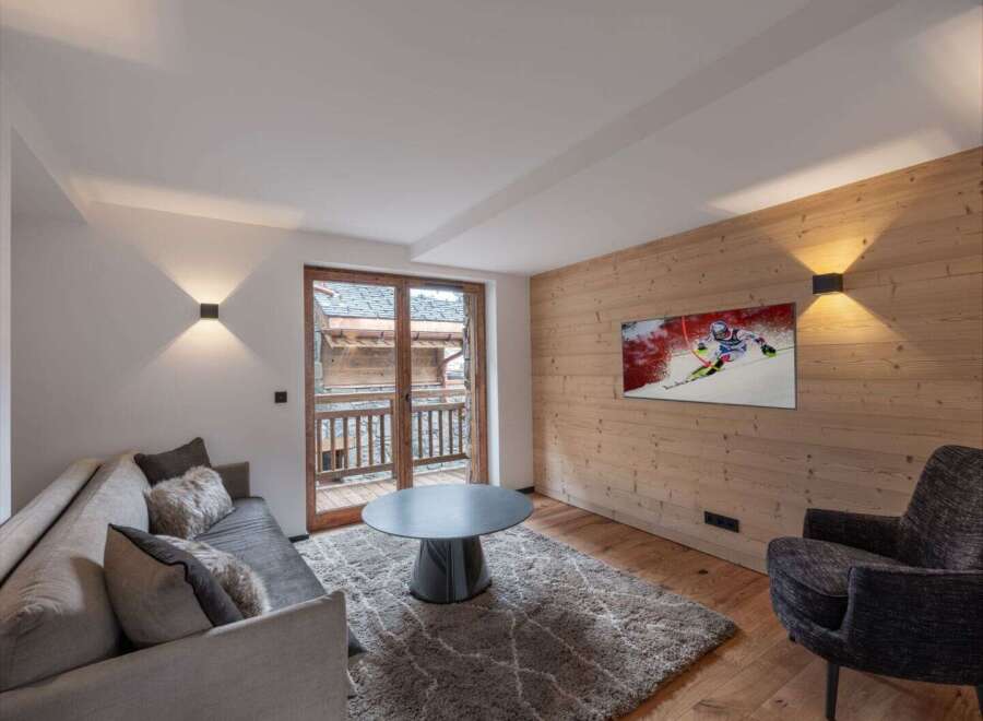 Experience luxury living in this stunning property, featuring a cozy living room with a modern design.