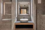 This modern bathroom showcases a sleek design with its minimalist aesthetic and high-end finishes.